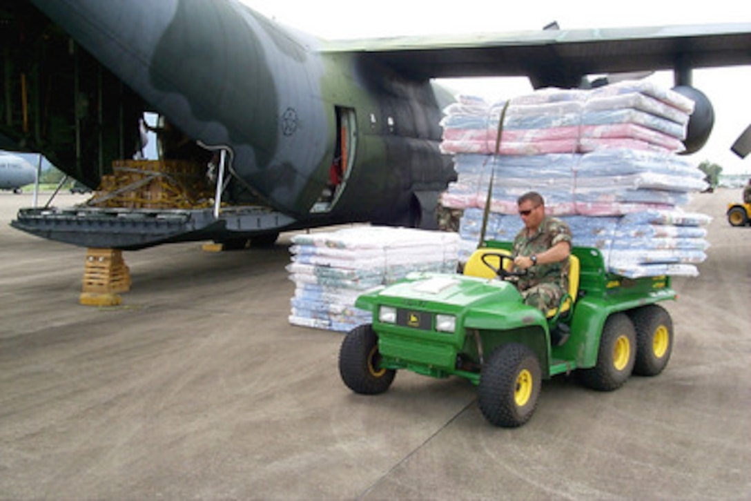 Mattresses and relief supplies for victims of Hurricane Mitch are unloaded from a West Virginia Air National Guard C-130 Hercules at the airport in La Cieba, Honduras, on Nov. 11, 1998. Over 1,000 U.S. service members are helping to rush food, shelter, pure water and medical aid to the central Americans made homeless by Hurricane Mitch. 