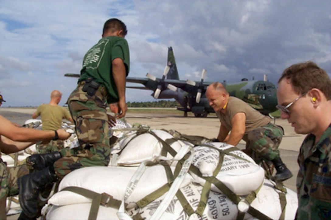 U.S. and Netherlands service men prepare pallets of rice sacks for victims of Hurricane Mitch to be loaded on to a West Virginia Air National Guard C-130 Hercules at the airport in La Mesa, Honduras, on Nov. 11, 1998. Over 1,000 U.S. service members are helping to rush food, shelter, pure water and medical aid to the central Americans made homeless by Hurricane Mitch. 