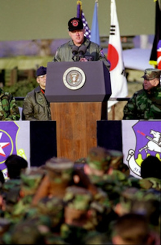 President Bill Clinton speaks to the U.S. troops at Osan Air Base, Republic of Korea, on Nov. 22, 1998. Clinton is spending the Sunday of his five-day Asian trip visiting the American service men and women stationed in South Korea and thanking them for their sacrifice and commitment to their nation. 
