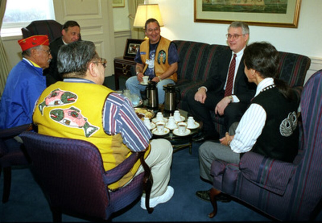 Deputy Secretary of Defense John J. Hamre (2nd from right) talks with a group of Native Americans in his Pentagon office on Nov. 10, 1998. These men will participate in a Department of Defense sponsored observance celebrating the contributions of Native Americans to the defense of the nation. Clockwise from the left foreground: Nelson Frank, a Sitka Tribal performer from Alaska; Samuel Tso, one of the famous World War II Navajo code talkers; David Oliver, principal deputy under secretary of defense for acquisition and technology; Edward Peele, a Sitka Tribal performer; Hamre; and Willard S. Jackson, a Sitka Tribal performer. 