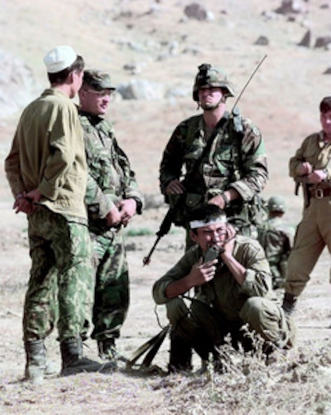 U.S. Army 1st Lt. James Newman (second from left) and Pfc. Rudunov (standing right) attempt to negotiate a treaty between the two dissident fictional nations during the final phase of Exercise CENTRAZBAT '98, in Osh, Kyrgyzstan, on Sept. 27, 1998. Exercise CENTRAZBAT '98 involves more than 450 military personnel from Azerbaijan, Georgia, Kazakhstan, Kyrgyzstan, Russia, Turkey, and Uzbekistan who are training with over 250 U.S. military troops to hone their peacekeeping skills. The exercise will enhance regional cooperation and increase interoperability training among NATO and Partnership for Peace nations. Newman and Rudunov are attached to the U.S. Army's 10th Mountain Division, Fort Drum, N.Y. 