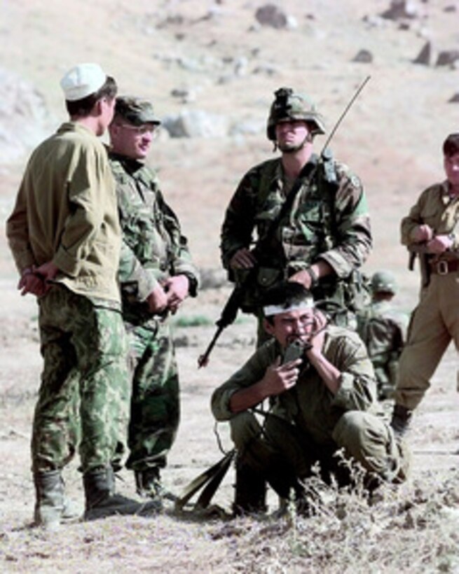 U.S. Army 1st Lt. James Newman (second from left) and Pfc. Rudunov (standing right) attempt to negotiate a treaty between the two dissident fictional nations during the final phase of Exercise CENTRAZBAT '98, in Osh, Kyrgyzstan, on Sept. 27, 1998. Exercise CENTRAZBAT '98 involves more than 450 military personnel from Azerbaijan, Georgia, Kazakhstan, Kyrgyzstan, Russia, Turkey, and Uzbekistan who are training with over 250 U.S. military troops to hone their peacekeeping skills. The exercise will enhance regional cooperation and increase interoperability training among NATO and Partnership for Peace nations. Newman and Rudunov are attached to the U.S. Army's 10th Mountain Division, Fort Drum, N.Y. 