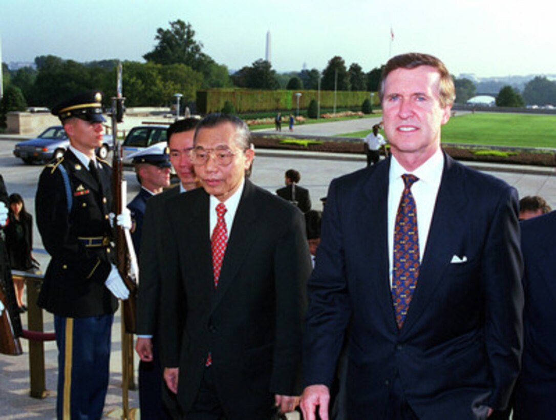 Secretary of Defense William S. Cohen (right) escorts visiting Deputy Prime Minister and Foreign Minister Nguyen Manh Cam (left), of the Socialist Republic of Vietnam, into the Pentagon on Oct. 1, 1998. The two men will meet to discuss a range of regional security issues. 