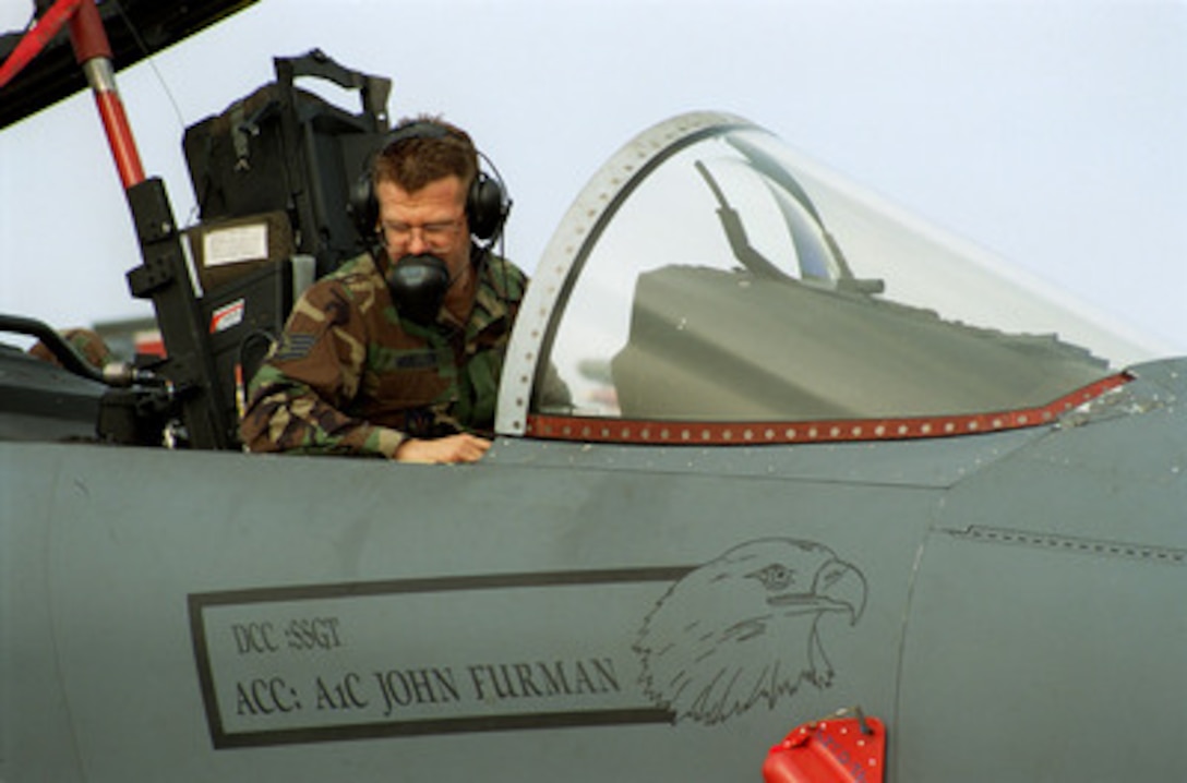 Staff Sgt. Barry Mueller, U.S. Air Force, monitors the systems' checks in the cockpit of a F-15E Eagle at R.A.F. Mildenhall, England, on Sept. 29, 1998. The Eagle is being prepared for deployment to a forward location as part of the four air expeditionary wings the U.S. Air Force has formed in support of possible NATO contingency operations in Kosovo. The F-15 Eagle is an all-weather, extremely maneuverable, tactical fighter designed to gain and maintain air superiority in aerial combat. Mueller is attached to the 494th Fighter Squadron R.A.F. Lakenheath, England. 