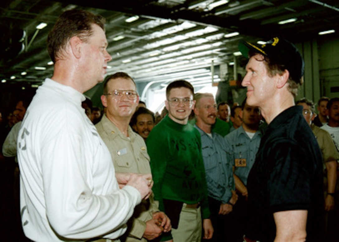 Secretary of Defense William S. Cohen (right) meets with some of the crew in the hangar deck of the USS Abraham Lincoln (CVN 72) on Oct. 9, 1998. The aircraft carrier is operating in the Persian Gulf in support of Operation Southern Watch, which is the U.S. and coalition enforcement of the no-fly-zone over Southern Iraq. Cohen is visiting U.S. ships and commands while he is in the Gulf region to meet with defense and national leaders. 