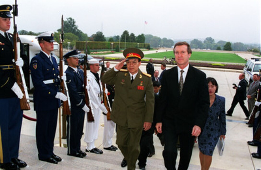 Secretary of Defense William S. Cohen (right) escorts Vice Minister of Defense Tran Hanh (left), of the Socialist Republic of Vietnam, through an armed forces honor cordon into the Pentagon on Oct. 5, 1998. 