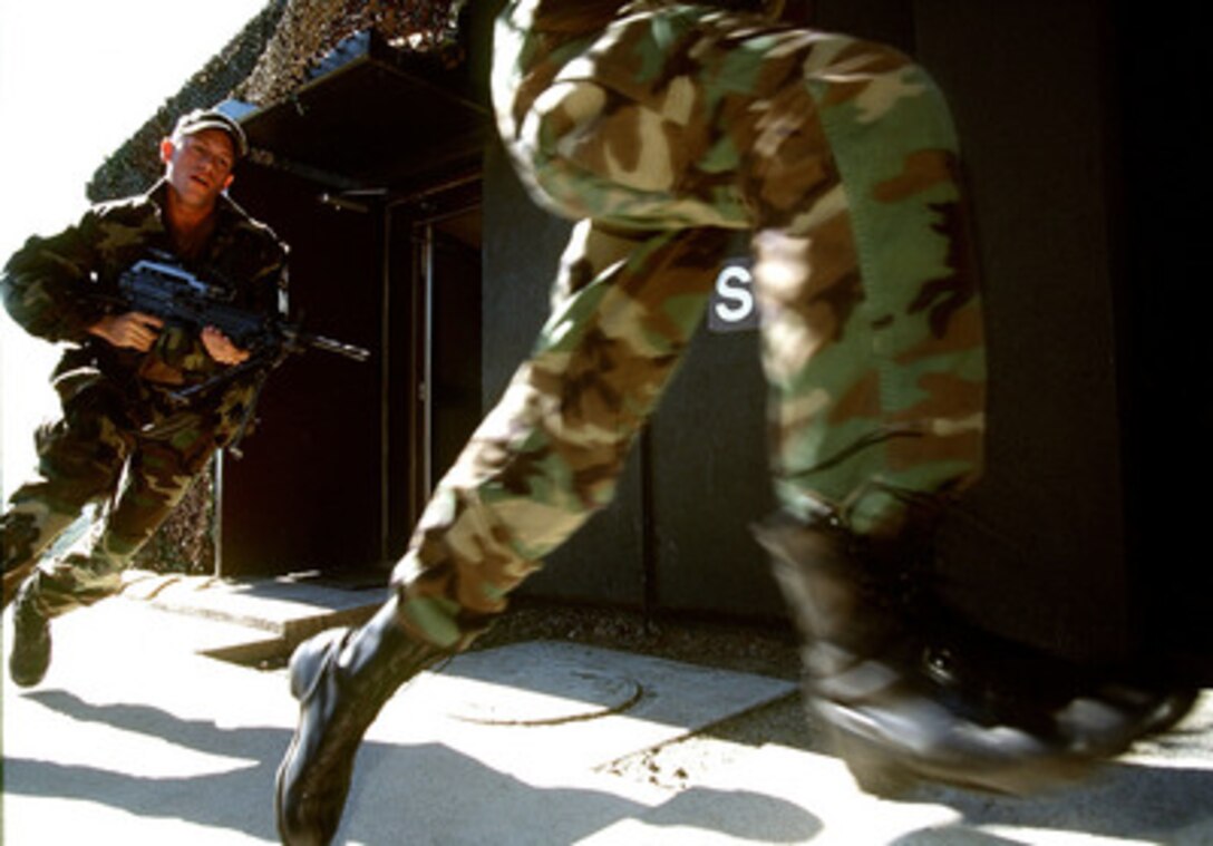 Members of the Joint Security Area Scout Platoon run to their positions as they react to an alarm during an alert drill at Observation Post Oullette in the Republic of Korea, on Oct. 20, 1998. The platoon practices the alert procedures along the Demilitarized Zone once a day to maintain their constant readiness. These U.S. Army soldiers are assigned to the United Nations Command Security Battalion. 