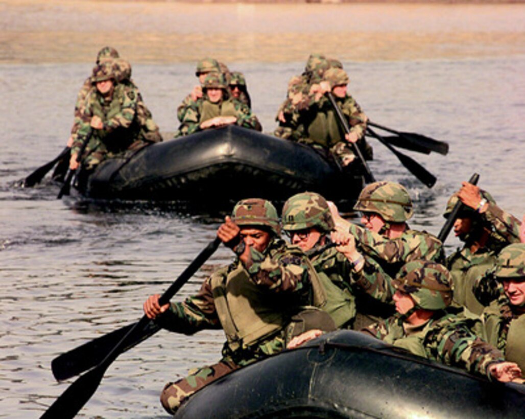 Soldiers assigned to the 50th Engineer Company, 1st Platoon, and the 2nd Battalion, 9th Infantry, paddle rubber rafts to cross the Imjin River in the Republic of Korea, on Oct. 22, 1998, during a simulated assault. Many of the soldiers are officers participating in the U.S. Army Officer Professional Development Program, which is designed to improve team building and soldiery. The 50th Engineers are from Camp Laguardia and the 9th Infantry are from Camp Casey in the Republic of Korea. 