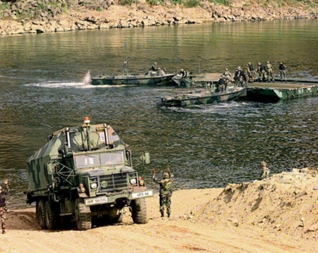 A U.S. Army M-945 Bridge Transporter is guided down to the river's edge in preparation for launching another section of floating bridge into the Imjin River in the Republic of Korea, during a bridge building training exercise on Oct. 22, 1998. Soldiers assigned to the 50th Engineer Company, 1st Platoon, and the 2nd Battalion, 9th Infantry, are participating in the exercise as part of the U.S. Army Officer Professional Development Program, which is designed to improve team building and soldiery. The 50th Engineers are from Camp Laguardia and the 9th Infantry are from Camp Casey in the Republic of Korea. 