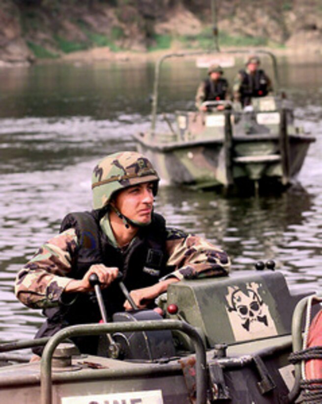 Pfc. George Damian operates the throttle of his Bridge Erection Boat during a bridge building training exercise on the Imjin River in the Republic of Korea, on Oct. 22, 1998. Soldiers assigned to the 50th Engineer Company, 1st Platoon, and the 2nd Battalion, 9th Infantry, are participating in the exercise as part of the U.S. Army Officer Professional Development Program, which is designed to improve team building and soldiery. The 50th Engineers are from Camp Laguardia and the 9th Infantry are from Camp Casey in the Republic of Korea. Damian is assigned to the 1st Platoon, 50th Engineers. 