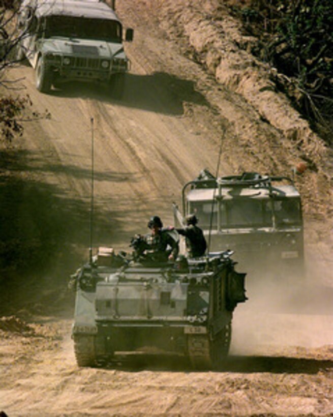 Soldiers assigned to C Troop of the 4th Squadron, 7th Cavalry Regiment drive an M-113A1 Armored Personnel Carrier to the live fire range at the Korea Training Center, Republic of Korea, on Oct. 25, 1998. Armored units use the range to meet yearly, live gunnery training requirements. 