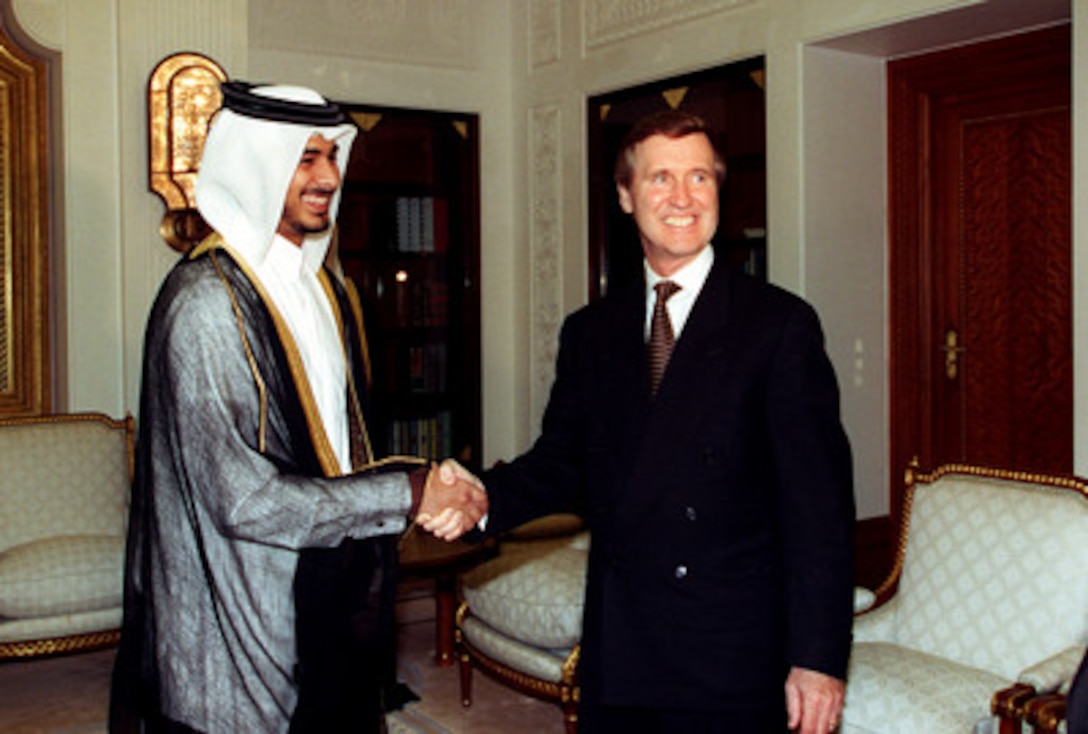 His Highness Crown Prince Sheikh Jassim bin Hamad bin Khalifa Al-Thani (left), of the State of Qatar, and Secretary of Defense William S. Cohen (right), pose for photographs prior to their meeting at the Emiri Diwan, Doha, on Oct. 10, 1998. Cohen is in the Persian Gulf region to visit with U.S. troops and heads of state in the Gulf countries. 