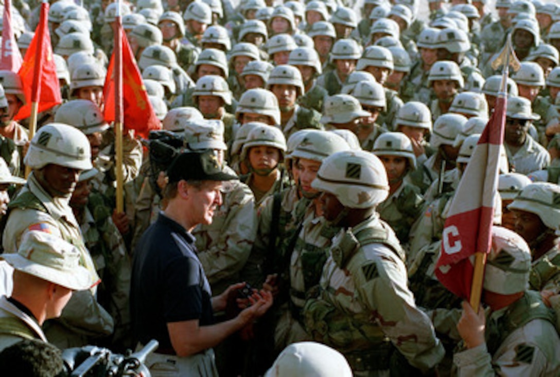 Secretary of Defense William S. Cohen mingles among the crowd of U.S. soldiers at Udairi Range, Kuwait, on Oct. 14, 1998. Personnel took the opportunity to ask questions and have their photograph taken with the defense secretary. Cohen is in the Persian Gulf region to visit with U.S. troops and heads of state in the Gulf countries. 