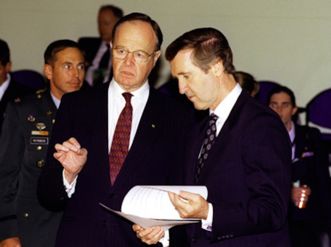 Australian Minister of Defense Ian McLachlan (left) and Secretary of Defense William S. Cohen (right) consult during a break at the annual Australia-United States Ministerial Consultations in Sydney, Australia, on July 31, 1998. The meetings are being held to discuss regional and global issues and to further the alliance between the U.S. and Australia. 