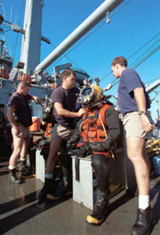 U.S. Navy divers from Mobile Diving Salvage Unit Two are prepared on the deck of the USS Grapple (ARS 53) to dive on the crash site of Swissair Flight 111 off the coast of Peggy's Cove, Nova Scotia, on Sept. 13, 1998. U.S. and Canadian forces are working together in the retrieval of victims and aircraft debris from the crash site. Grapple is the U.S. Navy's newest rescue and salvage vessel and can deploy Mobile Underwater Debris Survey System technology, Synthetic Aperture Sonar, and the Laser Electro-Optics Identification System to provide detailed images of the ocean floor. 