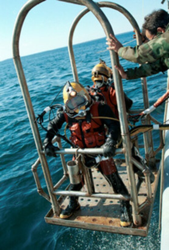 After completing 40 minutes of recovery work on the ocean floor U.S. Navy divers from Mobile Diving Salvage Unit Two are raised to the deck of the USS Grapple (ARS 53) at the crash site of Swissair Flight 111 off the coast of Peggy's Cove, Nova Scotia, on Sept. 13, 1998. U.S. and Canadian forces are working together in the retrieval of victims and aircraft debris from the crash site. Grapple is the U.S. Navy's newest rescue and salvage vessel and can deploy Mobile Underwater Debris Survey System technology, Synthetic Aperture Sonar, and the Laser Electro-Optics Identification System to provide detailed images of the ocean floor. 