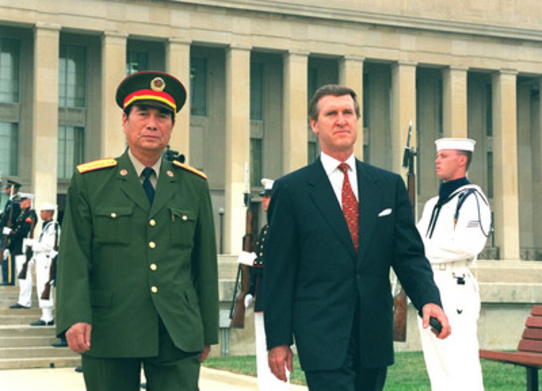 Secretary of Defense William Cohen (right) escorts his guest Gen. Zhang Wannian, vice chairman of the Central Military Commission, Peoples Republic of China, to the Pentagon parade field where he will be formally welcomed with a full honors arrival ceremony on Sept. 15, 1998. Zhang is visiting the Pentagon to attend meetings with Cohen and other senior Department of Defense officials. 