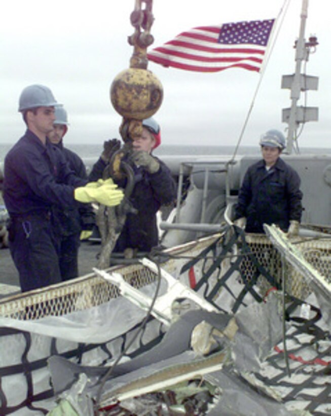 Crew members of the USS Grapple (ARS 53) hook up a basket containing debris from the crash site of Swissair Flight 111 for transfer to a barge during operations off the coast of Peggy's Cove, Nova Scotia, on Sept. 15, 1998. U.S. and Canadian forces are working together in the retrieval of victims and aircraft debris from the crash site. Grapple is the U.S. Navy's newest rescue and salvage vessel and can deploy Mobile Underwater Debris Survey System technology, Synthetic Aperture Sonar, and the Laser Electro-Optics Identification System to provide detailed images of the ocean floor. 