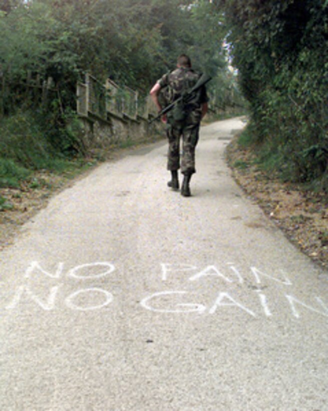 "No Pain No Gain" is the message given to the runners during the uphill portion of the course for the 30 kilometer Viking Run in the country side of Ilidza, Bosnia and Herzegovina, on Sept. 24, 1998. The Norwegian Army Telemark Company is hosting the Viking Run, an annual physical fitness test in the Norwegian Army. It consists of running 30 kilometers (18.5 miles) over rough terrain wearing a combat uniform, flack-jacket, long-barrel rifle, 2 full ammunition magazines, and a helmet totaling a minimum of 11 kilograms. One-hundred-five members of the NATO Stabilization Force are participating in the endurance run. 