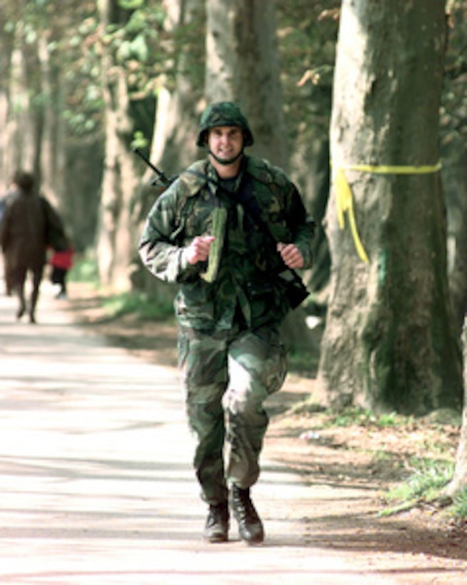 U.S. Marine Capt. Beau Higgins, of New Orleans, La., maintains a steady pace along the course as he nears the finishing point for the 30 kilometer Viking Run in the country side of Ilidza, Bosnia and Herzegovina, on Sept. 24, 1998. The Norwegian Army Telemark Company is hosting the Viking Run, an annual physical fitness test in the Norwegian Army. It consists of running 30 kilometers (18.5 miles) over rough terrain wearing a combat uniform, flack-jacket, long-barrel rifle, 2 full ammunition magazines, and a helmet totaling a minimum of 11 kilograms. One-hundred-five members of the NATO Stabilization Force are participating in the endurance run. Higgins finished the race in 3 hours, 25 minutes and 13 seconds. 