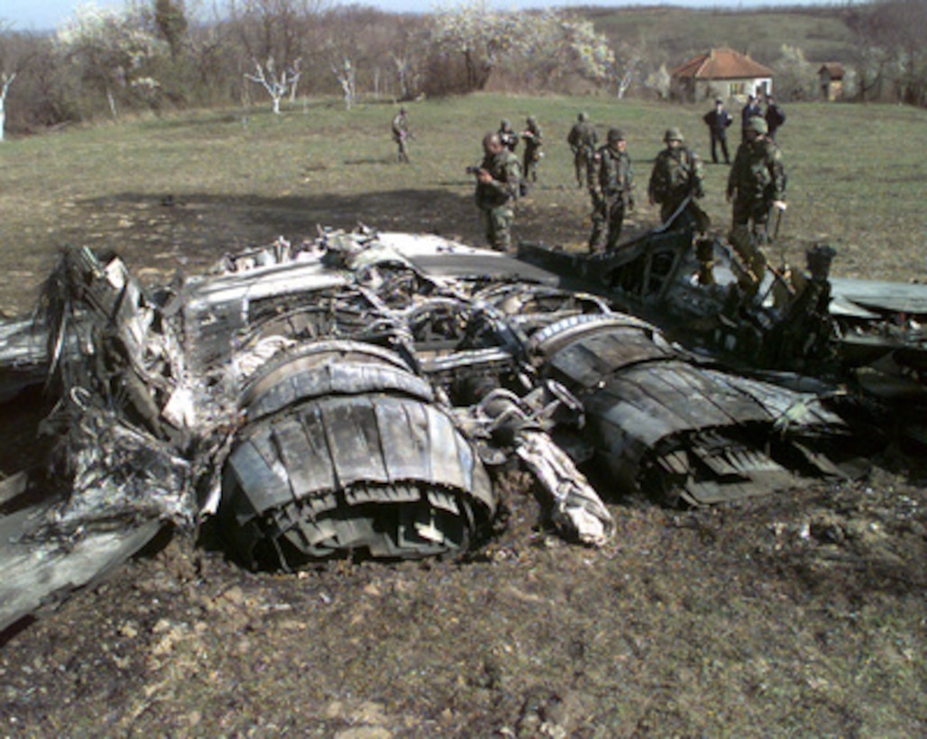 A U.S. Army documentation team surveys the wreckage of a Former Republic of Yugoslavia MiG-29 Fulcrum jet fighter outside the town of Ugljevik, Bosnia and Herzegovina, on March 27, 1999. The aircraft is one of two shot down by NATO forces during NATO Operation Allied Force. Operation Allied Force is the air operation against targets in the Federal Republic of Yugoslavia. 
