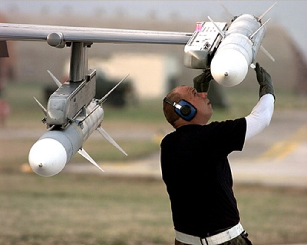 Senior Airman Thomas Kietur makes final checks on an AIM-120 Advanced Medium-Range Air-to-Air Missile attached to the wing of a U.S. Air Force F-16 Fighting Falcon at Aviano Air Base, Italy, on March 31, 1999. The Fighting Falcon is being prepared for an air strike mission in support of NATO Operation Allied Force which is the air operation against targets in the Federal Republic of Yugoslavia. Kietur is attached to the 22nd Fighter Squadron, Spangdahlem Air Base, Germany, and is deployed to Aviano in support of Allied Force. 