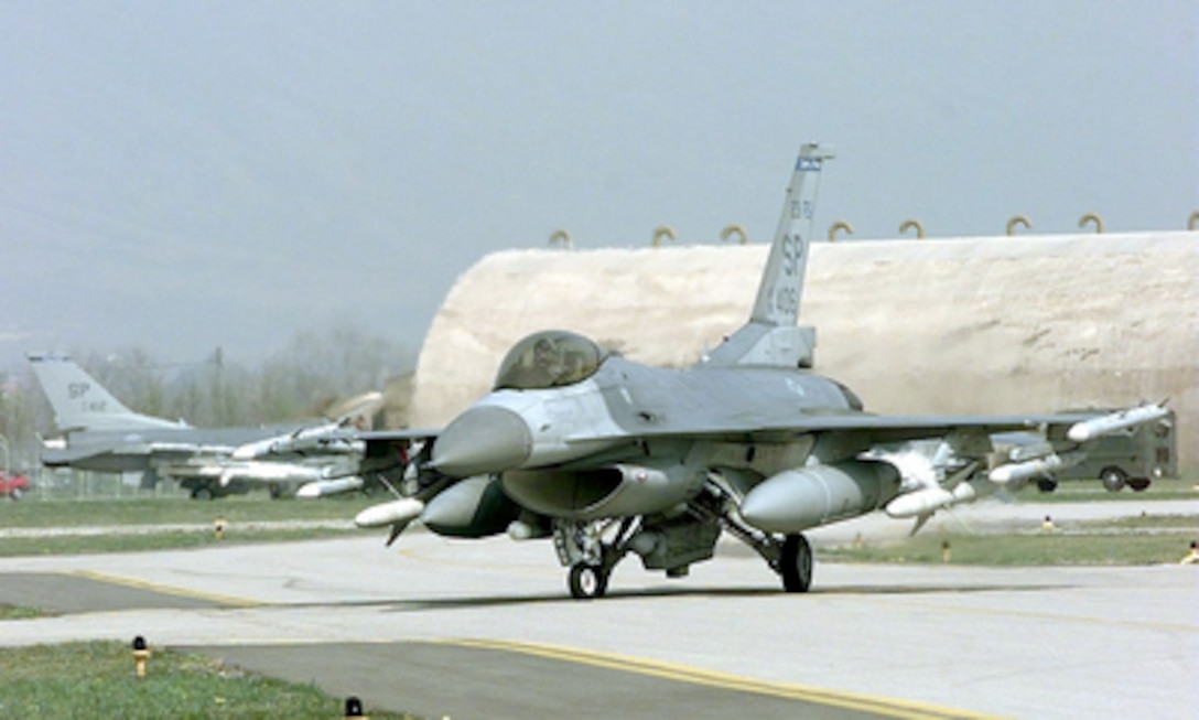 A U.S. Air Force F-16 Fighting Falcon taxis at Aviano Air Base, Italy, on April 2, 1999, after returning from flying a mission supporting NATO Operation Allied Force, which is the air operation against targets the Federal Republic of Yugoslavia. The Fighting Falcon is from the 52nd Fighter Wing based at Spandahlem Air Base, Germany. 