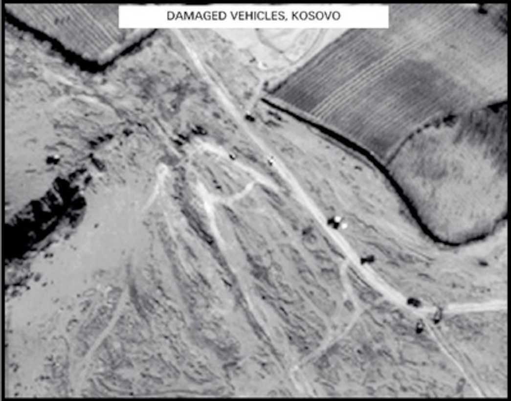 Post-strike bomb damage assessment photograph of Damaged Vehicles in Kosovo used by Joint Staff Director of Intelligence Rear Adm. Thomas R. Wilson, U.S. Navy, during a press briefing on NATO Operation Allied Force in the Pentagon on April 7, 1999. 