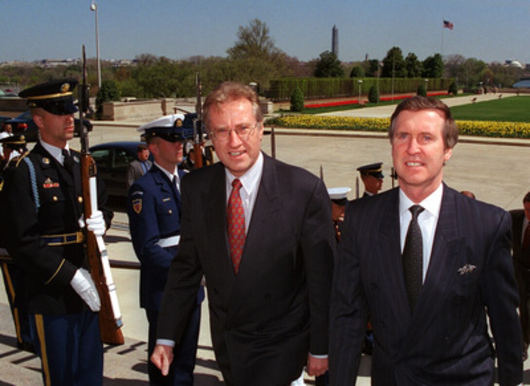Canadian Defense Minister Arthur Eggleton (center) arrives at the Pentagon, April 10, 1999, for a meeting with Secretary of Defense William Cohen (right). The main topic of the talks was the ongoing bombing campaign against Yugoslavia known as Operation Allied Force. 