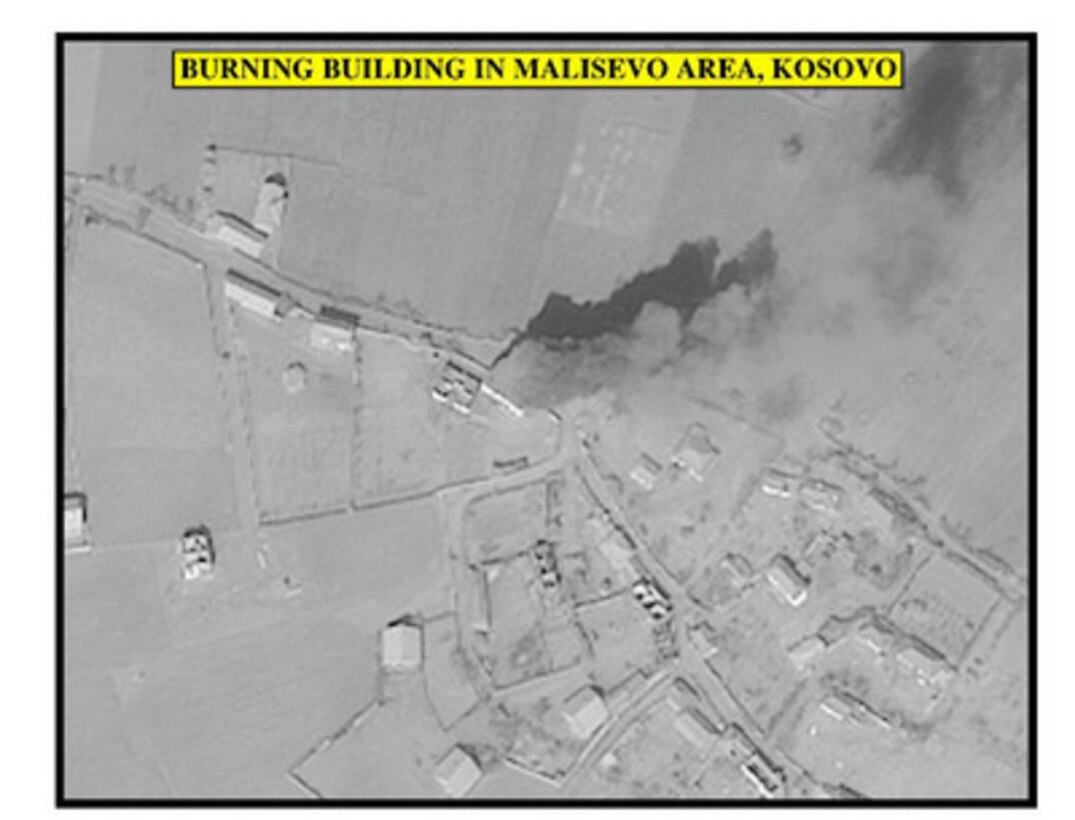Assessment photograph of a burning building in Malisevo area, Kosovo, used by Joint Staff Vice Director for Strategic Plans and Policy Maj. Gen. Charles F. Wald, U.S. Air Force, during a press briefing on NATO Operation Allied Force in the Pentagon on April 13, 1999. 