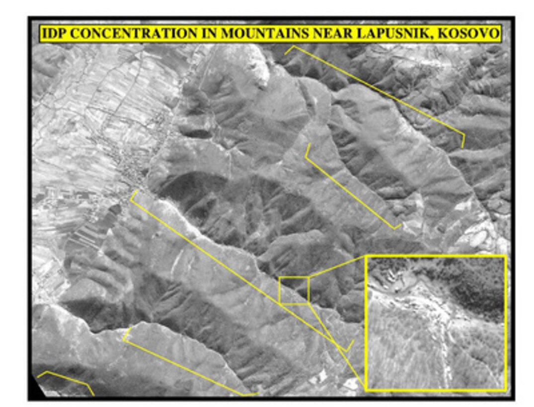 Photograph of internally displaced persons in mountains near Lapusnik, Kosovo, used by Joint Staff Vice Director for Strategic Plans and Policy Maj. Gen. Charles F. Wald, U.S. Air Force, during a press briefing on NATO Operation Allied Force in the Pentagon on April 17, 1999. 