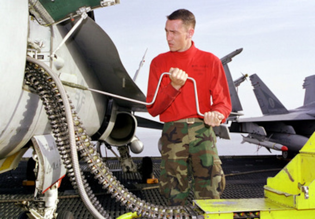 Cpl. Stephen Ramsey, U.S. Marine Corps, loads 20 mm machine gun rounds into an F/A-18C Hornet on the flight deck of USS Enterprise (CVN 65) on April 5, 1999. Enterprise and its embarked Carrier Air Wing 3 are on station in the Persian Gulf in support of Operation Southern Watch, which is the U.S. and coalition enforcement of the no-fly-zone over Southern Iraq. Ramsey is attached to Marine Fighter Attack Squadron 312. 