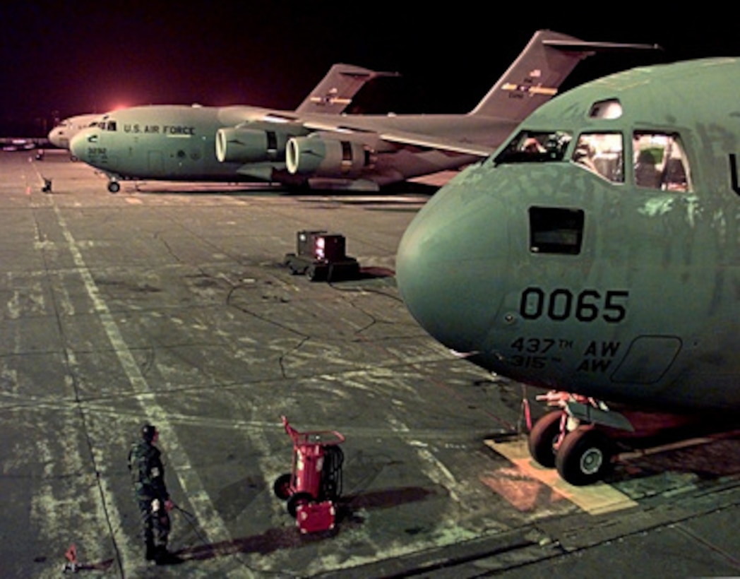 A U.S. Air Force C-17 Globemaster III comes to life on the ramp at Ramstein Air Base, Germany, as its crew prepares for a Operation Sustain Hope mission to Tiranë, Albania, on April 11, 1999. Operation Sustain Hope is the U.S. effort to bring in food, water, medicine, relief supplies, and to establish camps for the refugees fleeing from the Former Republic of Yugoslavia into Albania and Macedonia. The C-17 Globemasters are deployed from the 437 Airlift Wing, Charleston Air Force Base, S.C. 