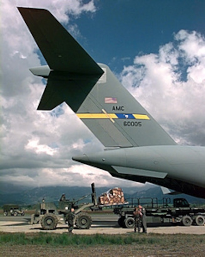 Relief supplies for Operation Sustain Hope are unloaded from a U.S. Air Force C-17 Globemaster III at Tiranë, Albania, on April 11, 1999. Operation Sustain Hope is the U.S. effort to bring in food, water, medicine, relief supplies, and to establish camps for the refugees fleeing from the Former Republic of Yugoslavia into Albania and Macedonia. The C-17 Globemasters are deployed from the 437 Airlift Wing, Charleston Air Force Base, S.C. 