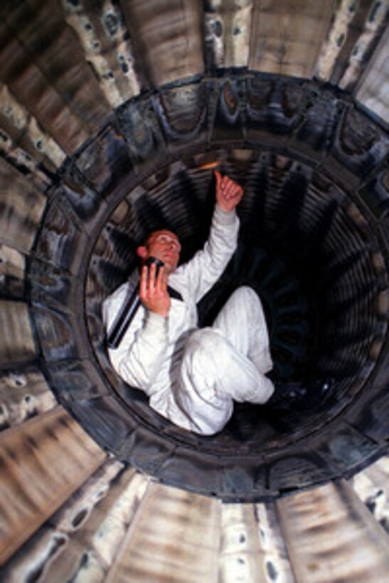 Senior Airman Matt LaNew examines the interior of the afterburner of a U.S. Air Force F-16 Fighting Falcon at Aviano Air Base, Italy, on April 12, 1999. Maintenance personnel are keeping pace with the maintenance associated with the increased operating tempo of NATO Operation Allied Force. Operation Allied Force is the air operation against targets in the Federal Republic of Yugoslavia. LaNew is attached to the 31st Air Expeditionary Wing. 