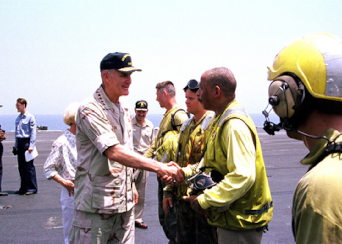 Chairman of the Joint Chiefs of Staff Gen. Henry H. Shelton (left), U.S. Army, shakes hands with crew members on the flight deck of the USS Theodore Roosevelt (CVN 71) on Aug. 19, 1999. The aircraft carrier is deployed to the Persian Gulf in support of Operation Southern Watch which is the U.S. and coalition enforcement of the no-fly-zone over Southern Iraq. Shelton is onboard the carrier during a visit to the Persian Gulf region. 