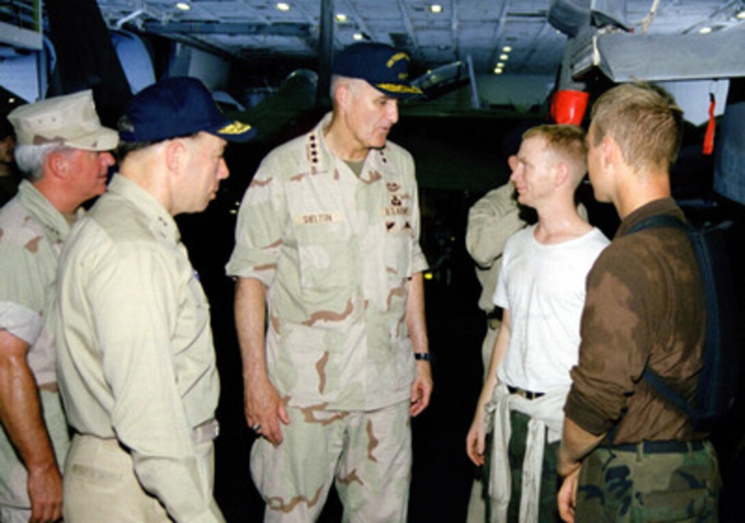 Crew members of the USS Theodore Roosevelt (CVN 71) talk on the hangar deck with Chairman of the Joint Chiefs of Staff Gen. Henry H. Shelton (center), U.S. Army, on Aug. 19, 1999. The aircraft carrier is deployed to the Persian Gulf in support of Operation Southern Watch which is the U.S. and coalition enforcement of the no-fly-zone over Southern Iraq. Shelton is onboard the carrier during a visit to the Persian Gulf region. 