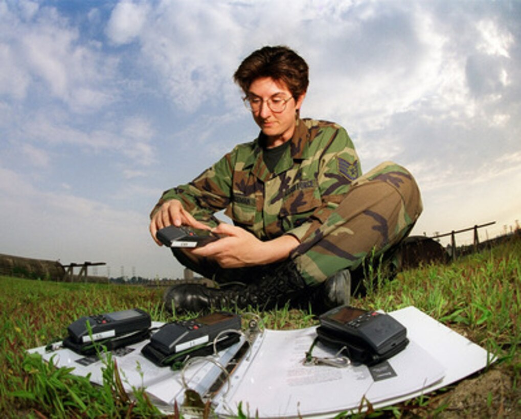 Staff Sgt. Barbara Bozeman, U.S. Air Force, demonstrates the operational check she performed on the hand-held Global Positioning System (GPS) units used by her squadron at Osan Air Base, South Korea, on Aug. 24, 1999. At midnight between Aug. 21 and 22 the clocks aboard all 24 GPS satellites automatically reset themselves to zero. The clocks count to 1,023 weeks before resetting to conserve memory space. The effects of the clocks resetting were not anticipated by all manufactures of equipment that utilizes the GPS satellites as a navigational reference point, date, and time. The GPS units are used to supplement the navigational equipment in the survival vests worn by the fighter pilots of the 25th Fighter Squadron. Bozeman, from Middletown, R. I., is the assistant non-commissioned officer in charge of Life Support for the 25th. 