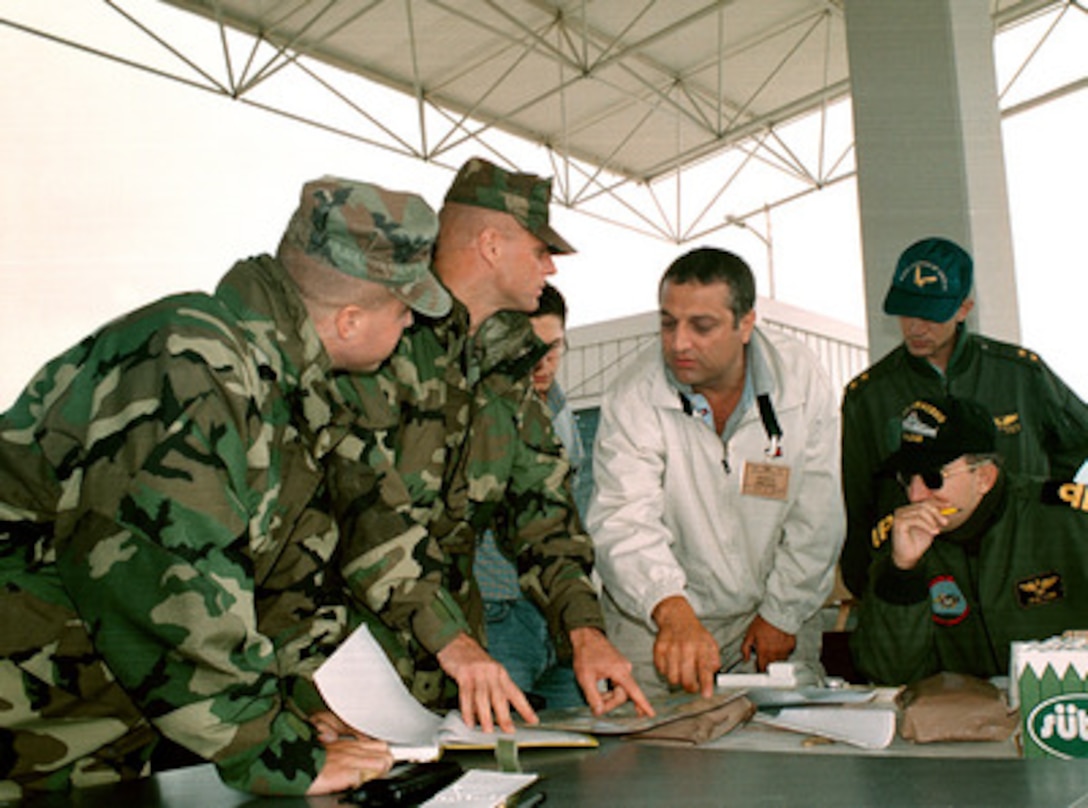 U.S. Marine Corps liaison officers and Turkish military officers plan the movement of relief supplies with a civilian contractor at Topel, Turkey, on Aug. 26, 1999. The Kearsarge Amphibious Readiness Group and the 26th Marine Expeditionary Unit are in Turkey to aid victims of the recent earthquake as part of Operation Avid Response. Avid Response is the U.S. military contribution to relief efforts following the earthquake that hit Western Turkey in the early morning hours of Aug. 17, 1999. 