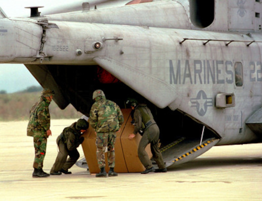 U.S. Marines from the 26th Marine Expeditionary Unit wrestle a pallet of bottled water out of a CH-53E Super Stallion helicopter at the Turkish Naval Base at Topel, Turkey, on Aug. 26, 1999. The Kearsarge Amphibious Readiness Group and the 26th Marine Expeditionary Unit are in Turkey to aid victims of the recent earthquake as part of Operation Avid Response. Avid Response is the U.S. military contribution to relief efforts following the earthquake that hit Western Turkey in the early morning hours of Aug. 17, 1999. The base and its surrounding civilian population has had no running water since the earthquake. 