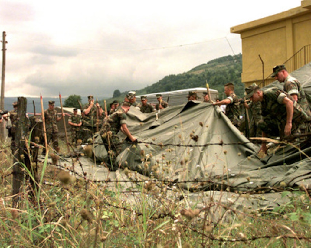 U.S. Marines from the 2nd Division, Light Armored Reconnaissance, Delta Company erect tents which will become shelter for homeless earthquake victims in Turkey on Aug. 28, 1999. The Kearsarge Amphibious Readiness Group and the 26th Marine Expeditionary Unit are in Turkey to aid victims of the recent earthquake as part of Operation Avid Response. Avid Response is the U.S. military contribution to relief efforts following the earthquake that hit Western Turkey in the early morning hours of Aug. 17, 1999. 