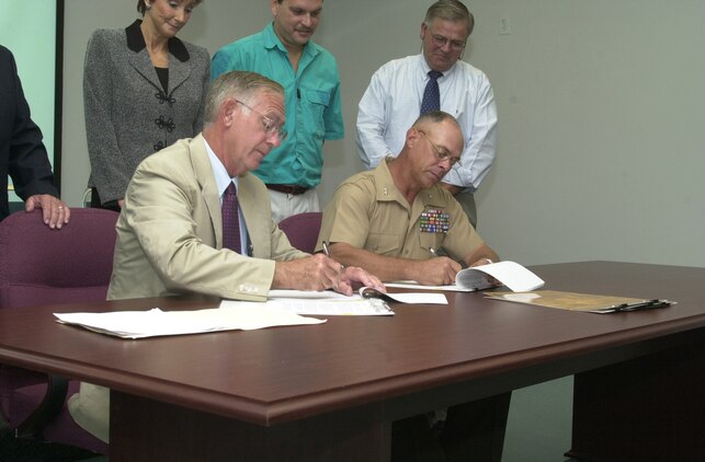 JACKSONVILLE, N.C. -- Major Gen. Robert C. Dickerson (right), commanding general of Marine Corps Installations East, and Richlands Mayor Marvin Trott (left), Onslow Water and Sewer Authority board of directors chairman, sign off on potable water and wastewater connection agreements at a signing ceremony at the ONWASA headquarters here Oct. 5. This agreement authorizes the first physical connection of ONWASA infrastructure to existing facilities at Camp Lejeune and will allow for the future expansion of water and sewer services to Onslow county residents. (Official U.S. Marine Corps photo by Lance Cpl. Brandon R. Holgersen)
