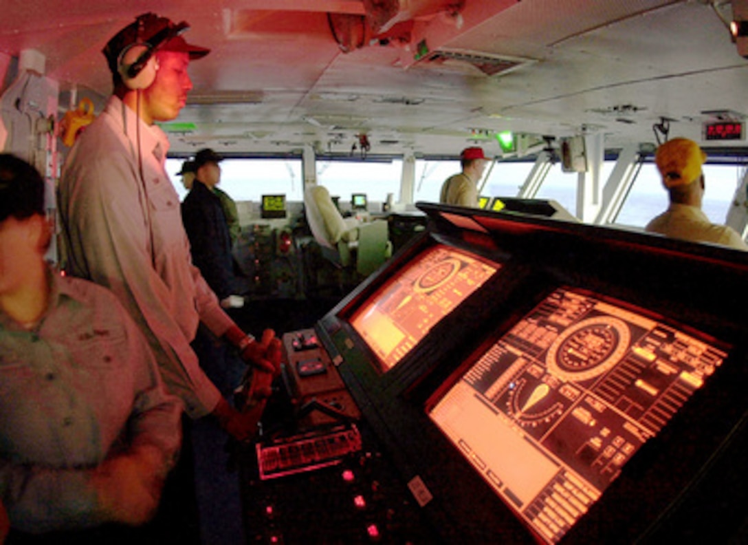 Seaman Shaun J. Toole mans the computerized helm of the USS Harry S. Truman (CVN 75) as the ship operates off the U.S. Atlantic coast on Dec. 10, 1999. Toole, from Brooklyn, N.Y., is steering the Navy's newest nuclear-powered aircraft carrier as it conducts Carrier Qualifications. 