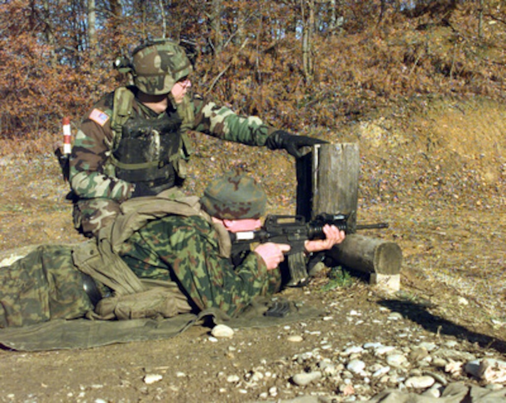 U.S. Army Sgt. Jonathan Taylor watches as a Russian paratrooper fires an M-4 Carbine during a joint training session at a firing range in Lazarevica, Republika Srpska, on Dec. 8, 1999. U.S. soldiers from A Company, 2nd Battalion, 502nd Infantry and Russian paratroopers from the Russian Separate Airborne Brigade cross trained on weapons of both nations. The soldiers are deployed as part of Multinational Division North, a peacekeeping unit supporting Operation Joint Forge in Bosnia and Herzegovina. 