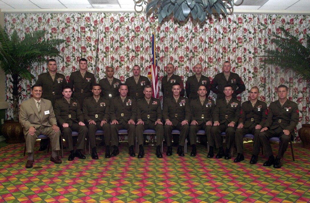 MYRTLE BEACH, S.C. - Marine Corps Engineer Association award winners stand and sit with Lt. Gen. Richard Kramlich, the deputy commandant for Installations and Logistics, Headquarters Marine Corps, Washington, D.C., at the 13th Annual Marine Corps Engineer Association Symposium Reunion here Oct. 13. The association recognized 18 individuals, from duty stations all over the Marine Corps, with plaques for their service in their respective jobs. Awards included being named the officer, staff noncommissioned officer, NCO, and Marine of their job field by the association. (Official U.S. Marine Corps photo by Lance Cpl. Brandon R. Holgersen)