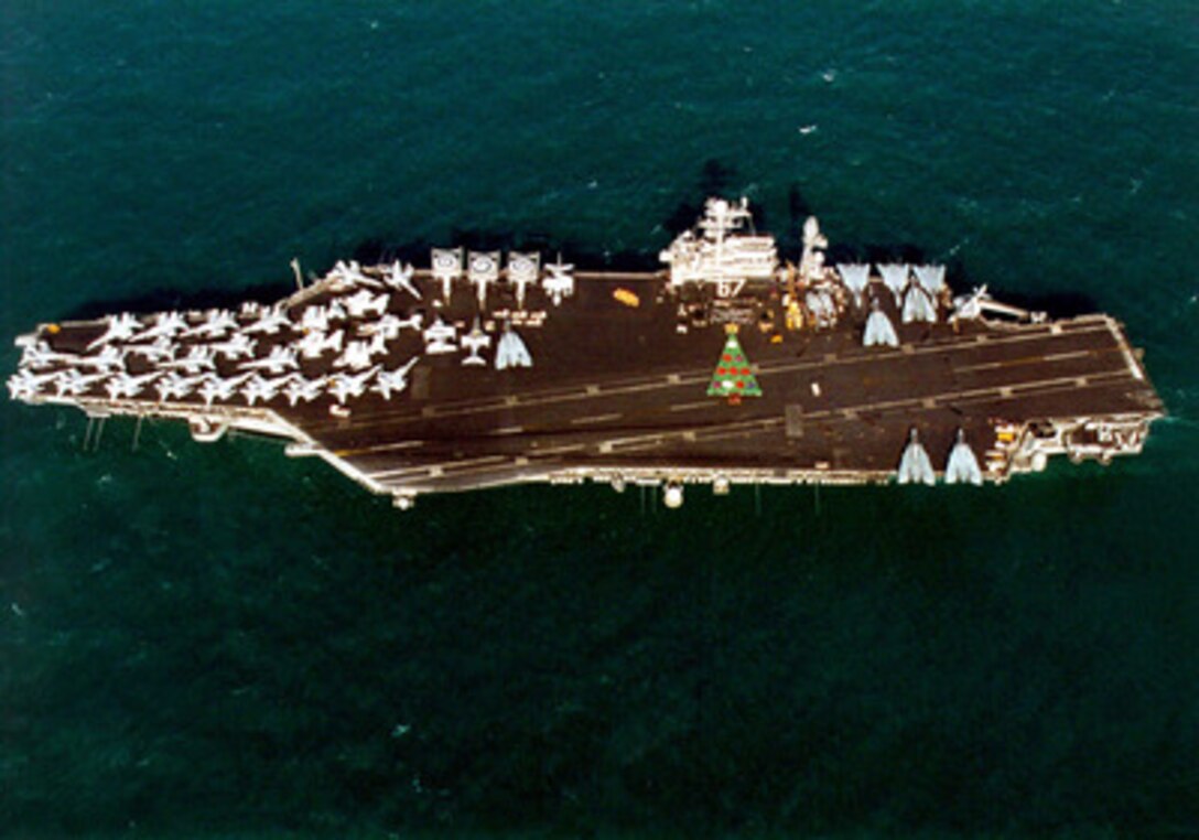 Over 1,000 sailors form a Christmas tree on the flight deck of the aircraft carrier USS John F. Kennedy (CV 67) as the ship operates in the Persian Gulf on Dec. 16, 1999. The Kennedy Battle Group is deployed to the Persian Gulf in support of Operation Southern Watch which is the U.S. and coalition enforcement of the no-fly-zone over Southern Iraq. 