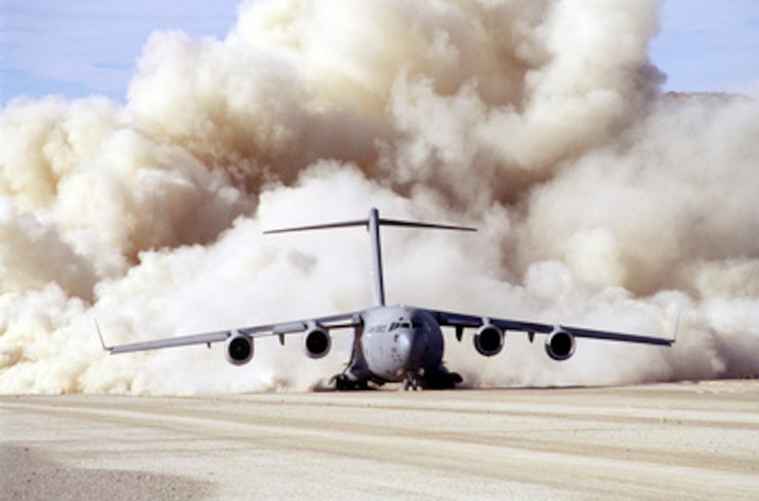 Clouds of dust billow out from behind a U.S. Air Force C-17 Globemaster III as it lands on the dry lake bed of Bicycle Lake at Fort Irwin, Calif., on Jan. 15, 1999. The 14th, 15th and 17th Airlift Squadrons from the 437th Air Wing at Charleston Air Force Base, S.C., are testing the performance of the Globemaster as it operates from a dirt airstrip. 