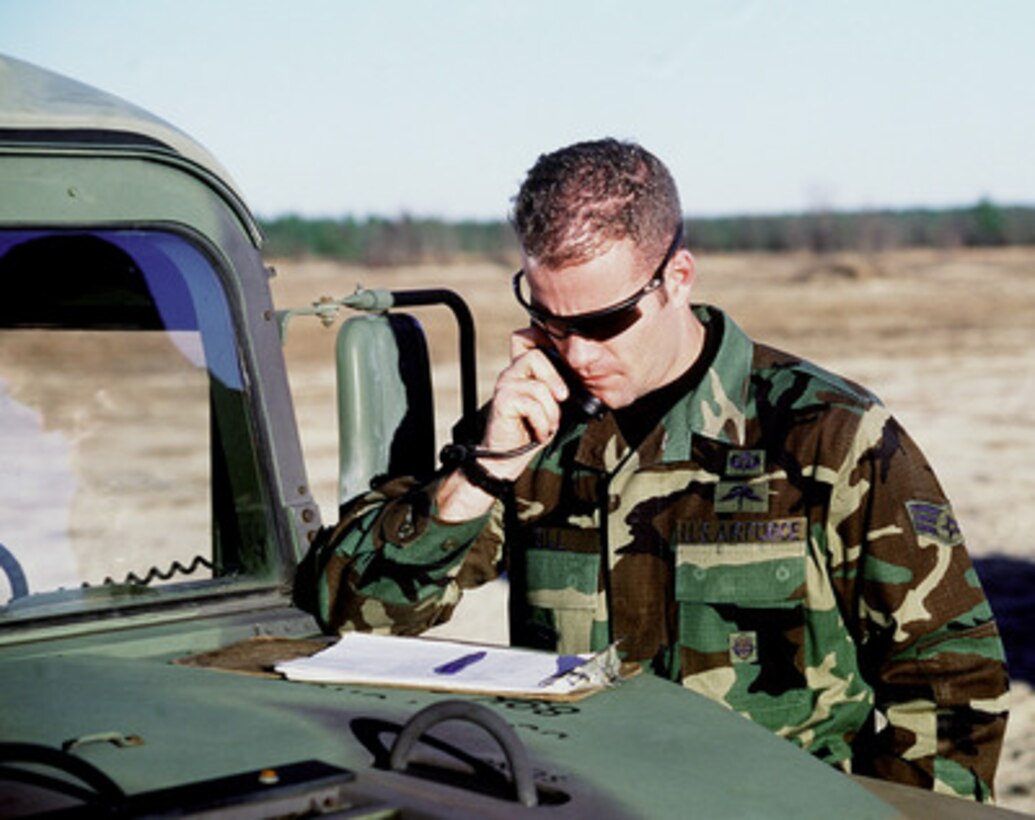 Combat Controller Senior Airman John Noll, U.S. Air Force, relays wind speed and wind direction to jump masters in U.S. Air Force C-141 Starlifter aircraft en route to the Normandy drop zone at Fort Bragg, N.C. on Jan. 20, 1999. Noll, a combat controller for the 21st Special Tactics Squadron, is participating in Large Package Week, a joint exercise involving Air Force aircraft operating from Pope Air Force Base, N.C., and soldiers of the U.S. Army's 82nd Airborne, at Fort Bragg. 