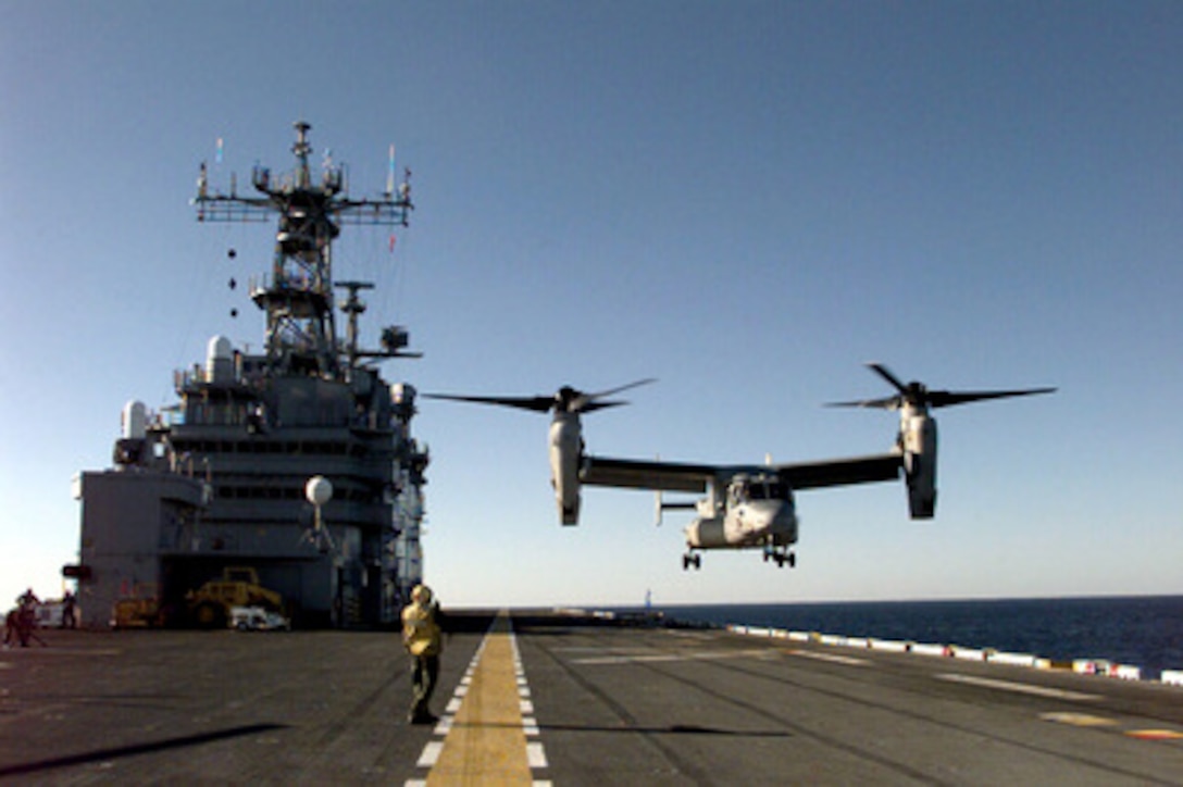 An MV-22 Engineering and Manufacturing, Development Osprey aircraft makes its landing approach to the flight deck of the USS Saipan (LHA 2) during deck landing qualifications on Jan. 16, 1999. The Saipan is the base for the aircraft's month-long sea trials which are designed to establish the parameters for all phases of operation of the aircraft on a Tarawa class amphibious assault ship like the Saipan. The Osprey, with its unique tilt rotor design, will eventually replace the CH-46 Sea Stallion helicopter. 