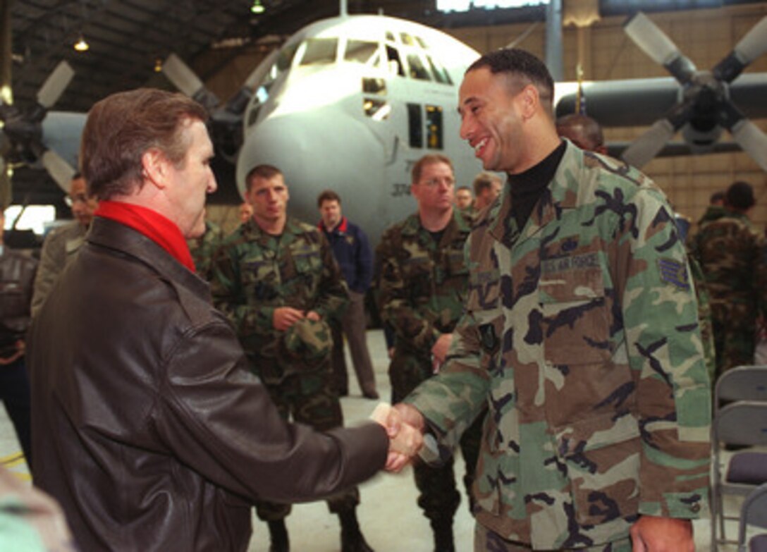 Secretary of Defense William Cohen (left) is greeted by Staff Sgt. Spear of the U.S. Air Force 374th Airlift Wing, during his visit to Yokota Air Base, Japan, on Jan. 12, 1999. Cohen is visiting the base as part of a five-day trip to Japan and the Republic of Korea. 